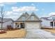 Inviting exterior of a lovely home with a well-maintained lawn and double garage doors at 595 Everton Pl, Grayson, GA 30017