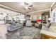 Open-concept living room with hardwood floors, a ceiling fan, and views into kitchen at 595 Everton Pl, Grayson, GA 30017