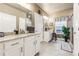Bright main bathroom with dual sinks, granite counters, and tile floors at 595 Everton Pl, Grayson, GA 30017