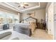 Inviting main bedroom with tray ceiling, carpet, and natural light at 595 Everton Pl, Grayson, GA 30017