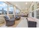 Enclosed sunroom with ample seating, natural light, and neutral decor at 595 Everton Pl, Grayson, GA 30017