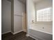 Clean bathroom with a shower, bathtub, and window at 604 Beaujolais Ct, Mcdonough, GA 30253