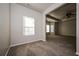 Main bedroom with window, carpet, and access to other rooms at 604 Beaujolais Ct, Mcdonough, GA 30253