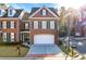 Brick front townhouse with a two-car garage and well-manicured lawn at 108 Magnolia Grv, Alpharetta, GA 30022