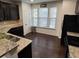 Kitchen with granite countertops and dark brown cabinets at 1957 Paxton Sw Dr, Lilburn, GA 30047