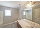 Bathroom featuring a double sink vanity, large mirror and bathtub at 324 Mary Dr, Mcdonough, GA 30252
