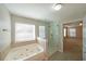 Bathroom featuring a soaking tub, glass shower, and tile accents at 324 Mary Dr, Mcdonough, GA 30252