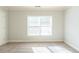 Well-lit bedroom with carpet and large window at 129 Janney Cir, Mcdonough, GA 30253