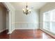 Elegant dining room, hardwood floors, wainscoting, and chandelier at 129 Janney Cir, Mcdonough, GA 30253
