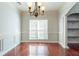 Formal dining room with hardwood floors, wainscoting, and chandelier at 129 Janney Cir, Mcdonough, GA 30253