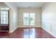 Spacious foyer with hardwood floors and wainscoting at 129 Janney Cir, Mcdonough, GA 30253
