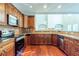 Kitchen with dark wood cabinets, granite counters, and stainless steel appliances at 129 Janney Cir, Mcdonough, GA 30253