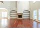Two-story living room with hardwood floors and stone fireplace at 129 Janney Cir, Mcdonough, GA 30253