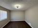 Third bedroom with neutral walls and dark wood flooring at 2326 Union Grove Ct, Lithonia, GA 30058