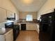 Updated kitchen with black appliances and tile backsplash at 2326 Union Grove Ct, Lithonia, GA 30058