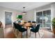 Modern dining room with teal chairs and sliding glass doors at 790 Gettysburg Ne Trl, Kennesaw, GA 30144