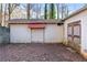 Tan colored storage shed with roll-up door at 790 Gettysburg Ne Trl, Kennesaw, GA 30144