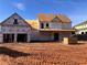 Incomplete construction of a beautiful two-story home with a covered porch and attached garage at 1937 Pucketts Sw Dr, Lilburn, GA 30047
