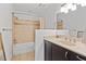 Well-lit bathroom featuring updated vanity, large mirror, a shower with tile accents, and tile floors at 1827 Rockridge Pl, Atlanta, GA 30324