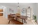 Modern dining room with a rustic table and bench, hardwood floors, minimalist décor and a view to the kitchen at 1827 Rockridge Pl, Atlanta, GA 30324