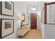 Bright foyer with hardwood floors, a wooden front door with an arched window, and decorative table, creates a warm entry at 1827 Rockridge Pl, Atlanta, GA 30324