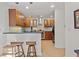 Well-lit kitchen featuring wooden cabinets, stainless steel appliances, and a breakfast bar with stool seating at 1827 Rockridge Pl, Atlanta, GA 30324