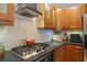 Functional kitchen featuring dark cabinets, granite countertops, stainless steel appliances, and tile backsplash at 1827 Rockridge Pl, Atlanta, GA 30324