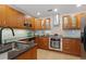 Functional kitchen featuring dark cabinets, granite countertops, stainless steel appliances, and tile backsplash at 1827 Rockridge Pl, Atlanta, GA 30324