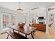 Cozy living room area connected to the dining room with hardwood floors, rustic table and bench, and lots of natural light at 1827 Rockridge Pl, Atlanta, GA 30324