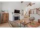 Bright and modern living room with hardwood floors, a fireplace, a large TV, and a staircase with white and wood railing at 1827 Rockridge Pl, Atlanta, GA 30324