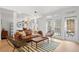 Open-concept living room with hardwood floors, lots of windows and natural light, modern furniture and direct access to the yard at 1827 Rockridge Pl, Atlanta, GA 30324