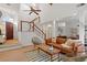 Inviting living room with vaulted ceiling, hardwood floors, modern furniture, and a staircase with white and wood railing at 1827 Rockridge Pl, Atlanta, GA 30324