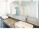 Bright bathroom features granite counters, square sinks, modern faucets and large illuminated mirrors at 1586 Sungrown Way, Mcdonough, GA 30253