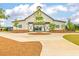 Spacious community clubhouse boasting modern barn doors, attractive landscaping, and a welcoming entrance at 1586 Sungrown Way, Mcdonough, GA 30253