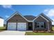 Charming brick home featuring a two-car garage, manicured lawn, and elegant black shutters adding curb appeal at 1586 Sungrown Way, Mcdonough, GA 30253