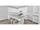 Bright kitchen featuring white cabinets, stainless steel appliances, a stylish island, and modern finishes at 1586 Sungrown Way, Mcdonough, GA 30253