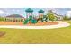 Community playground surrounded by lush landscaping featuring a playset, swings, and a covered pavilion with seating at 1586 Sungrown Way, Mcdonough, GA 30253