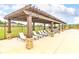 Poolside lounge area featuring comfortable seating under a stylish pergola, perfect for relaxation and enjoyment at 1586 Sungrown Way, Mcdonough, GA 30253