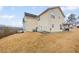 Two-story home featuring a spacious yard, a patio set, and mature trees at 1450 Riverrock Trl, Riverdale, GA 30296