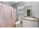 Well-lit bathroom featuring a shower, toilet, and vanity with a granite countertop at 1450 Riverrock Trl, Riverdale, GA 30296