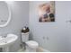 Traditional powder room features a pedestal sink, oval mirror, and tasteful wall art at 1450 Riverrock Trl, Riverdale, GA 30296