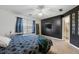 Comfortable bedroom with neutral carpeting, a statement wall, and natural light from the large window at 1450 Riverrock Trl, Riverdale, GA 30296