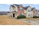 Charming two-story home with well-maintained landscaping and a welcoming covered porch in a cozy neighborhood at 1450 Riverrock Trl, Riverdale, GA 30296