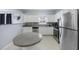 Stylish kitchen with stainless steel appliances, white cabinets, tile backsplash, and a granite-topped island table at 1450 Riverrock Trl, Riverdale, GA 30296