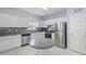 Bright kitchen featuring white cabinets, stainless steel appliances, and stylish backsplash at 1450 Riverrock Trl, Riverdale, GA 30296