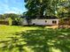 Expansive backyard with green grass, sliding glass doors, and wooden deck at 30 N Cleveland Church Rd, Mcdonough, GA 30253