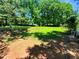 Spacious, grassy backyard with mature trees, offering a serene outdoor setting at 30 N Cleveland Church Rd, Mcdonough, GA 30253