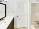 Bathroom featuring white cabinets, tile flooring, and a shower with glass door at 30 N Cleveland Church Rd, Mcdonough, GA 30253