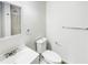 Well-lit bathroom features a white vanity, toilet, and shower with white tile surround at 30 N Cleveland Church Rd, Mcdonough, GA 30253
