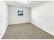 Cozy bedroom with neutral carpet, white walls, closet, and a window overlooking the backyard at 30 N Cleveland Church Rd, Mcdonough, GA 30253